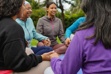 Fototapeta premium Women circle doing healing meditation outdoor - Multi generational people with different body and ethnic - Mindfulness, connection and community concept - Focus on hands