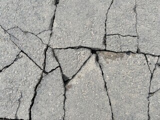 Obraz premium Horizontal picture of cracks smooth asphalt, numerous deep faults.