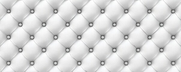 Fototapeta premium A close-up of a white, tufted surface with button detailing, creating a repeating pattern