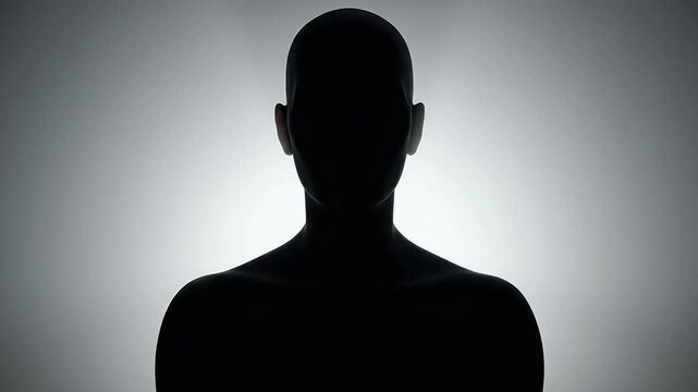 Human silhouette backlit against a foggy gray background representing anonymity and mystery with a focus on the outline of a person s head and