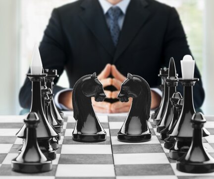 Wooden chess figures on a classic chessboard