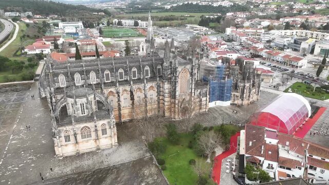 Drone orbit from Nuno &Aacute;lvares Pereira statue to cloisters of Batalha Monastery
