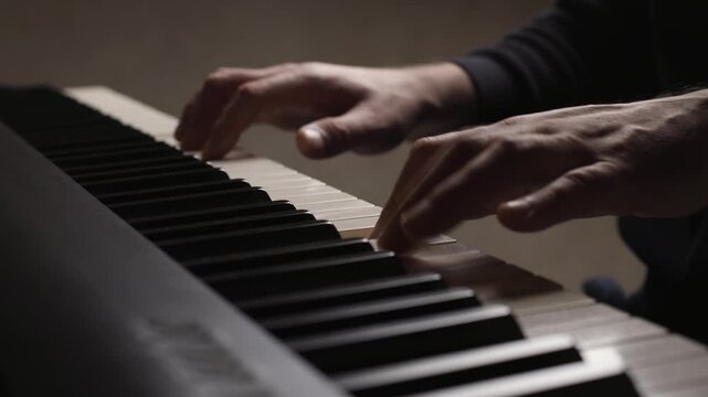 Close-up of beginner pianist, male hands practicing on a electronic piano keyboard