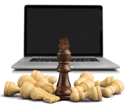 Wooden chess figures on a classic chessboard