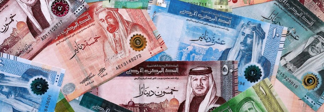 Jordanian dinar money bills pile on table. Jordan banknotes of JOD currency close up.