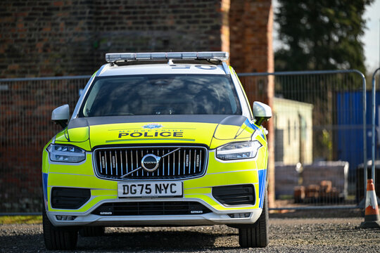 A parked Merseyside Police ANPR emergency traffic car showing the hi-visibility yellow and blue reflective batternberg.