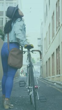 Vertical video: Cyclist walking alley, shifting grip, activating AR transit lines, checking route