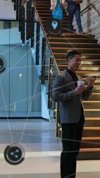 Vertical video: Man standing by stairs lifting phone coordinating as team pass biz HUD overlaying