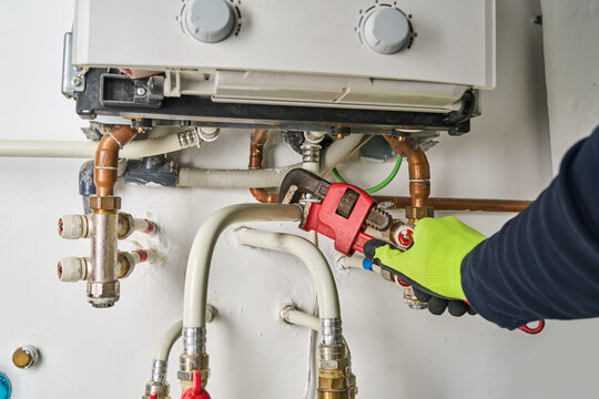 Plumber working at home, work at the heating installation at home