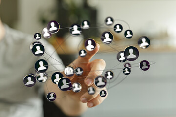 Hand touching network of people icons, representing social connection, communication, and digital technology.