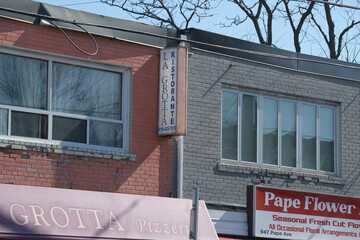 Naklejka premium wall mounted projecting sign outside La Grotta Pizzeria located at 951 Pape Av, East York Toronto (Pape Flower Market, 947 Pape Av)