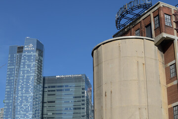 Naklejka premium contrast of architectural structures: Delta hotel and Southcore Financial Centre business center (Marsh & Mclennan) and historic concrete coaling tower, John Street Roundhouse, Toronto