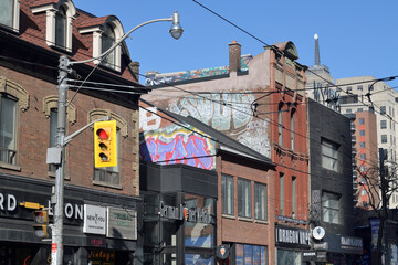 Naklejka premium looking northeast, north side on Queen St W to historic and contemporary commercial properties, from John St, Toronto