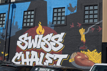 Naklejka premium graffiti inspired mural on the exterior wall of Swiss Chalet Express, a restaurant chain, located here at 722 Pape Av, Toronto