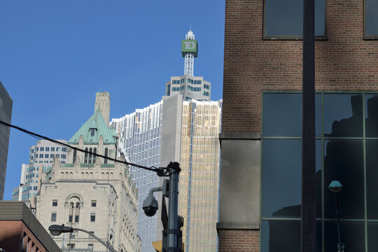 contrast of architecture styles: Fairmont Royal York hotel, RBC Royal Bank Plaza, South Tower, and beacon with corporate logo sign on top of TD Canada Trust Tower, Toronto