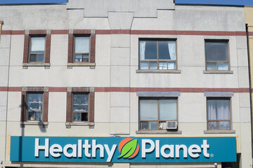 Naklejka premium exterior building facade and sign of Healthy Planet at 568 Danforth Av, Toronto