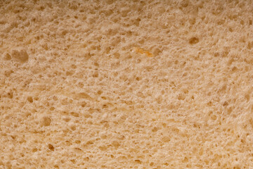 Close-up of a slice of bread showing the texture, air pockets, and the natural details. Perfect for food, healthy eating