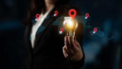 A businesswoman stands confidently, holding a glowing light bulb representing innovation. Behind, a world map showcases location markers, symbolizing market opportunities. Gantry © InfiniteFlow