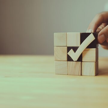 Business approval and quality verification concept with wooden blocks and checkmark symbol representing certification, successful validation, project completion and trusted business process.