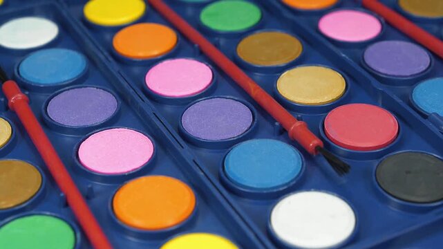 Watercolor paints for painting. Watercolor palette for painting projects. Artist watercolor sets with brushes for creative work