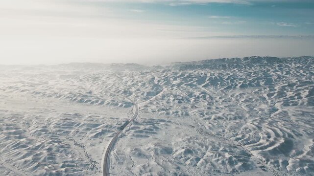 Aerial Highway Through Snow-Covered Xinjiang Mountains