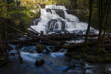 forgotten cascade waterfall in the woods high water flow slow motion white skirts