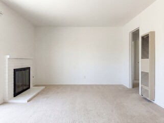 Fototapeta premium Empty living room with white brick fireplace and beige carpet