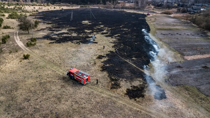 firefighters extinguish dry grass aerial view from a drone © Polivan
