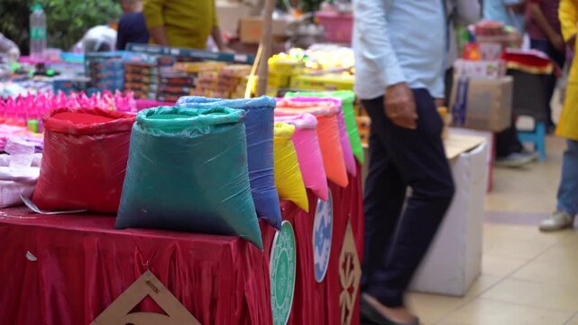 Vibrant packets of colored gulal powder displayed at a market stall for the Indian festival of colors Holi, symbolizing celebration, joy, and traditional spring festivities.