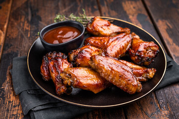 Deliciously sticky teriyakis sauce chicken wings, bursting with flavor, perfect for sharing at festive occasions or family dinners. wooden background. top view