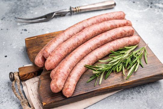 Freshly made raw sausage displayed elegantly, perfect for gourmet cooking or casual gatherings with friends. grey background. top view