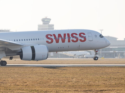 PRAGUE, CZECH REPUBLIC - MARCH 2026: Close-up of a Swiss International Air Lines Airbus A350-900 nose and cockpit during landing at Prague Airport (PRG) with control tower in background.