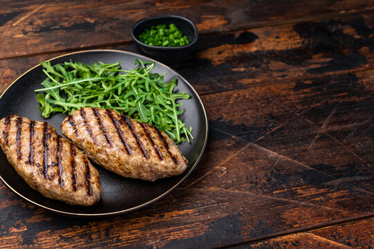 A platter of flavorful bbq roast kofta kebabs, beautifully garnished with vegetables and ready to delight your taste buds. wooden background. top view