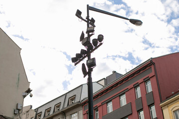 Lamppost city street, colorful facades and cloudy sky, urban detail capturing neighborhood