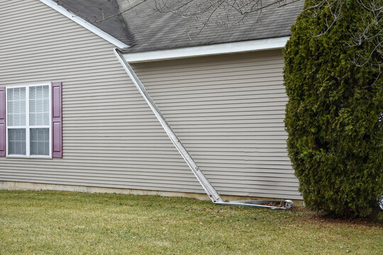 Gutter that has broken away from the side of a house