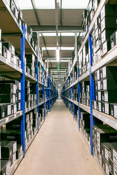Well-organized e-commerce warehouse or stockroom with industrial shelving systems used for efficient product storage and order fulfillment.