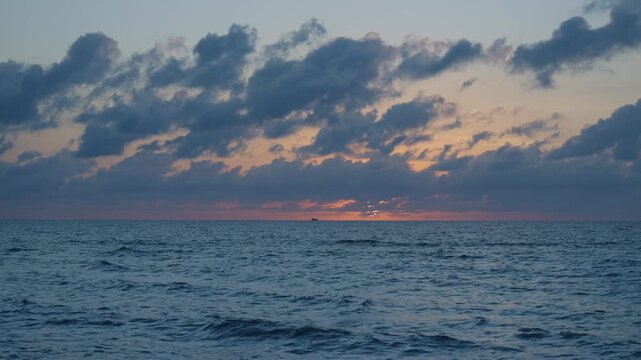 Sea sunset horizon. Sunset cloudy sky. Seascape at summer vacation. Skyscape with sea horizon. Horizon sunrise sea with ship. Sunrise seascape. Romantic summer vacation seascape