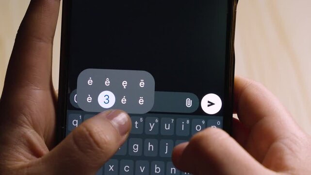 Close-up of hands typing a French apology "Je suis desole" on a smartphone. Concept of regret, empathy, and digital communication in a dark-themed interface.