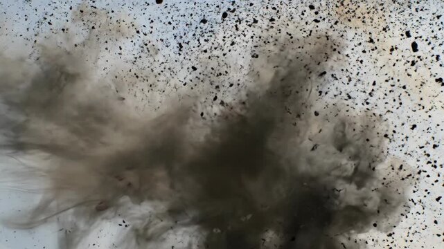 Dramatic explosion with dust and debris creating cloud, showcasing powerful forces in motion. Explosion demonstrates chaotic energy and vivid scattering of particles.