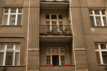 Ornate corner turret anchoring city streetscape with bay window and cornices, rounded facade blending into row of rooftops, detailed molding © Alena