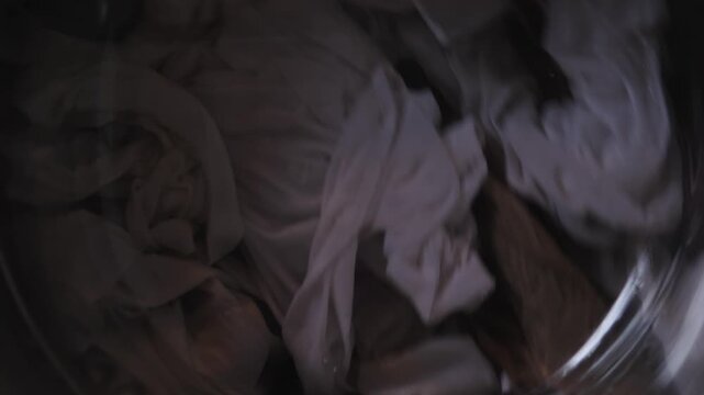 Soft Whites And Linen Spinning In Washing Machine Drum Showing Brightening Rinse Hotel Linen Care Or Wardrobe Refresh With Whitening Action, Crisp Folds And Gentle Rotation Under Muted