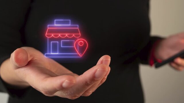 Woman's hand holding a shop icon with location pin symbol, animated in neon light	