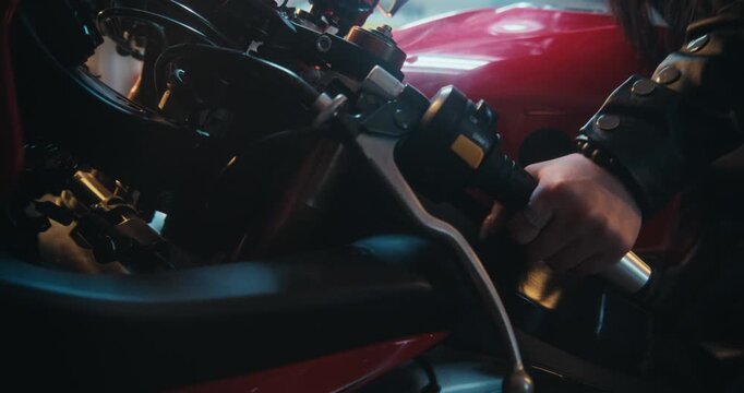 Close Up of Female Rider Securing Helmet Visor While Sitting on Sport bike in Garage. Asian Woman in Black Leather Outfit Secures Helmet and Closes Visor, Ready For High Speed Travel on Motorcycle.