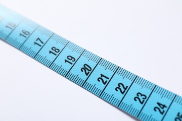 One measuring tape on white background, closeup