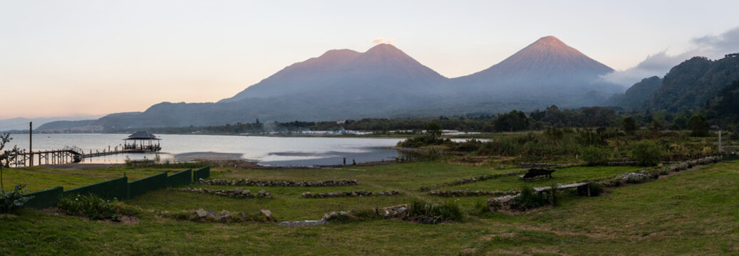 Atitlan lake at sunset with volcanos toliman and atitlan in the background. Tranquility and idyllic atmosphere perfect for relaxation
