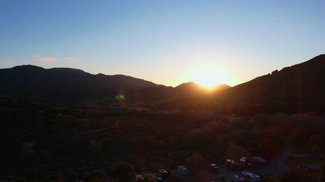 drone footage of an rv campground in the mountains at sunset
