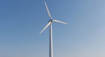 Fototapeta premium A tall white wind turbine with three blades stands against a clear blue sky, generating renewable energy.