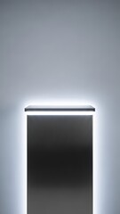 Tall dark gray rectangular display pedestal with a brushed texture, framed by bright white light strips on a plain light gray background