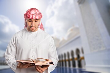 Arabic lantern with burning candle and book