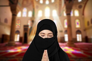 A muslim people with an open book in his hands.